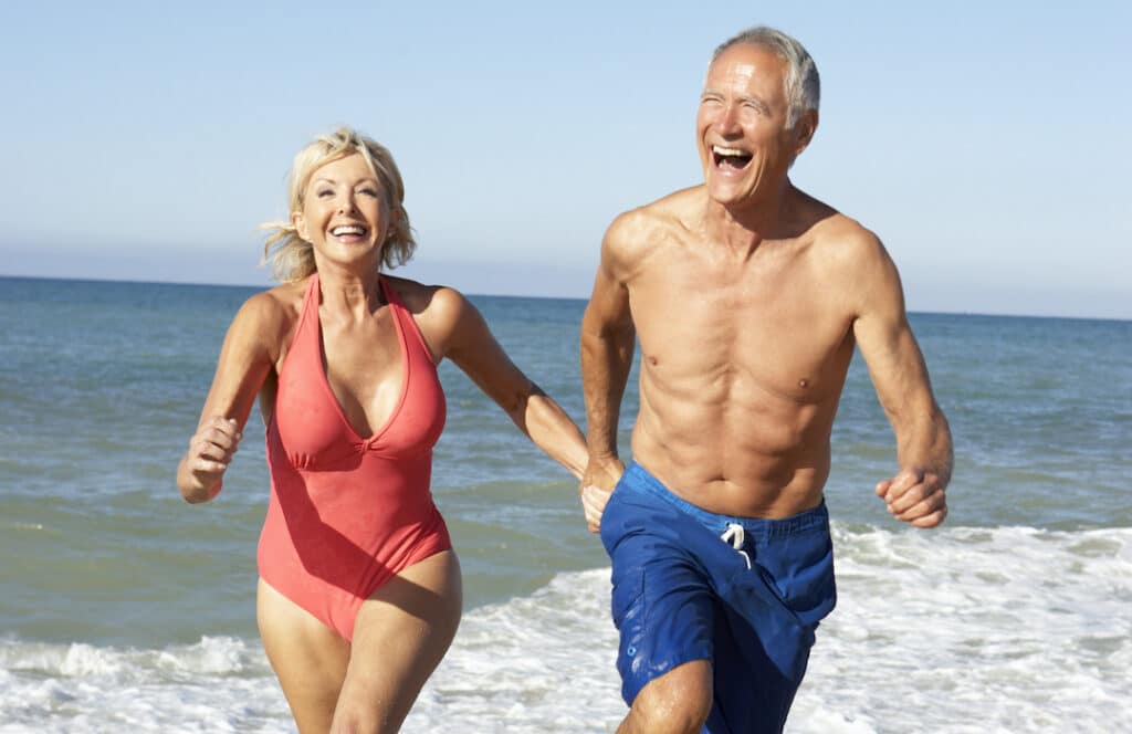 Weight loss Treatments - Senior Couple Enjoying Beach Holiday